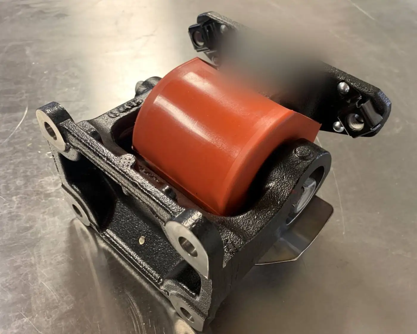 Iron cab mount assembly with polyurethane bushing