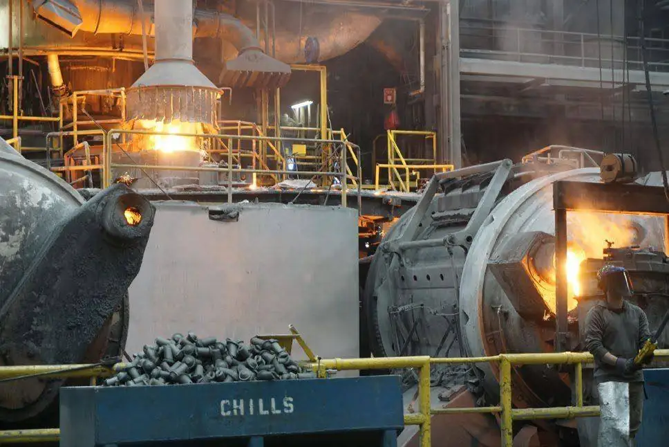 Melt deck at an iron foundry with ladles and charge material