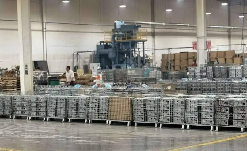 Baskets of finished cast parts staged on a plant floor