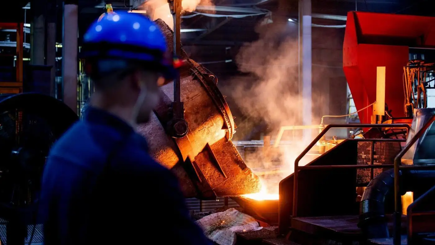 Foundry operator monitoring a ladle pour