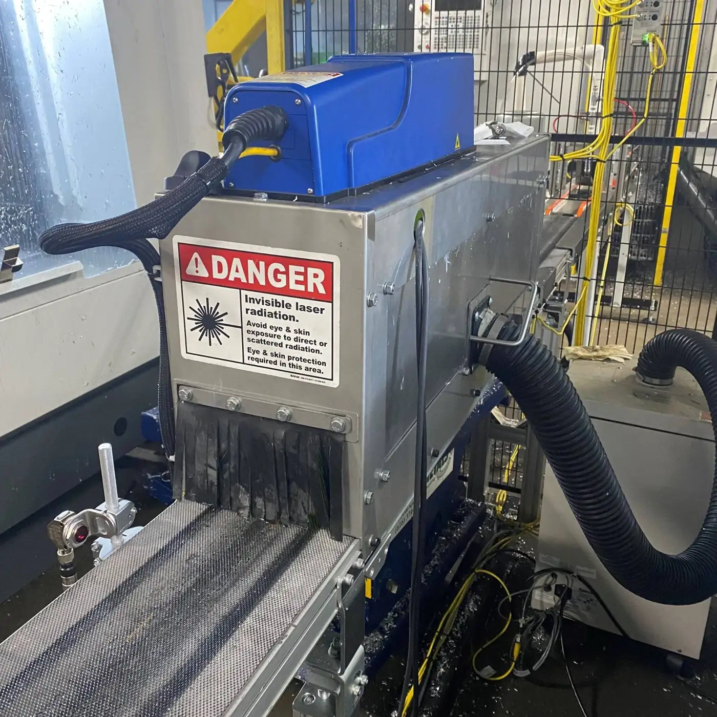 Laser marking station on a parts conveyor