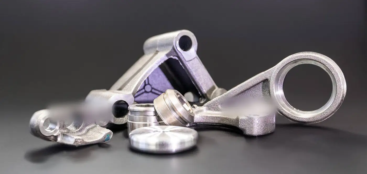 Assortment of machined iron castings on a dark background
