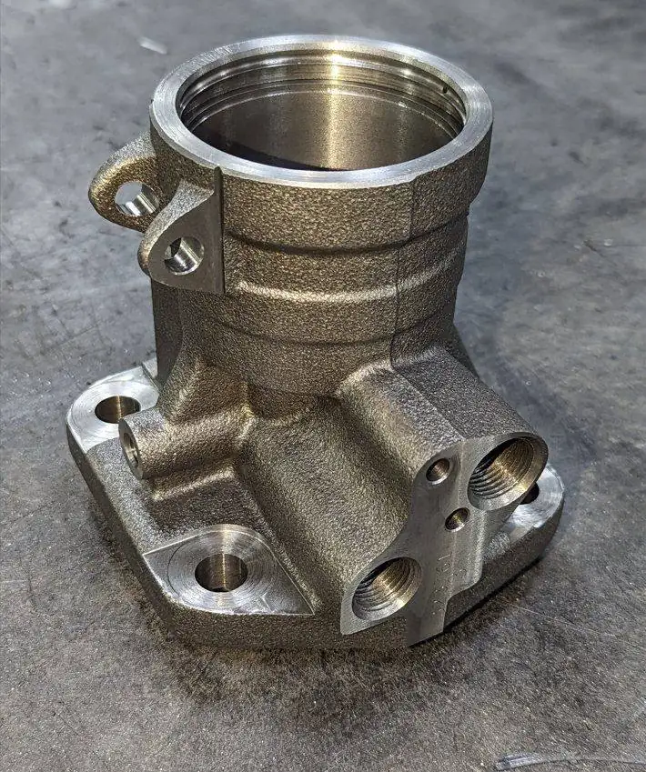 Machined cast valve housing with threaded ports