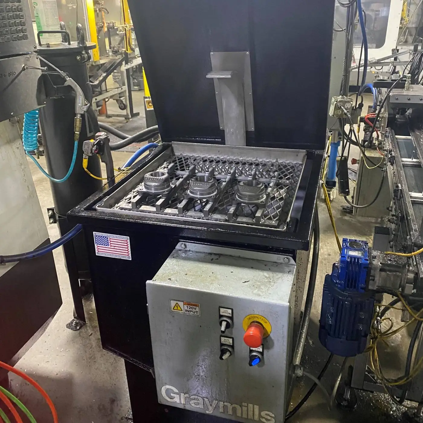 Industrial parts washer loaded with machined housings