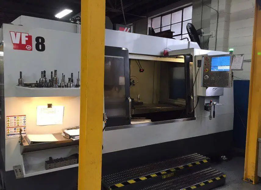 Vertical machining center with tooling staged